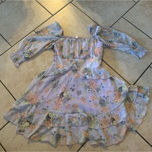 Beautiful purple flowy dress with floral print and puff shoulders.